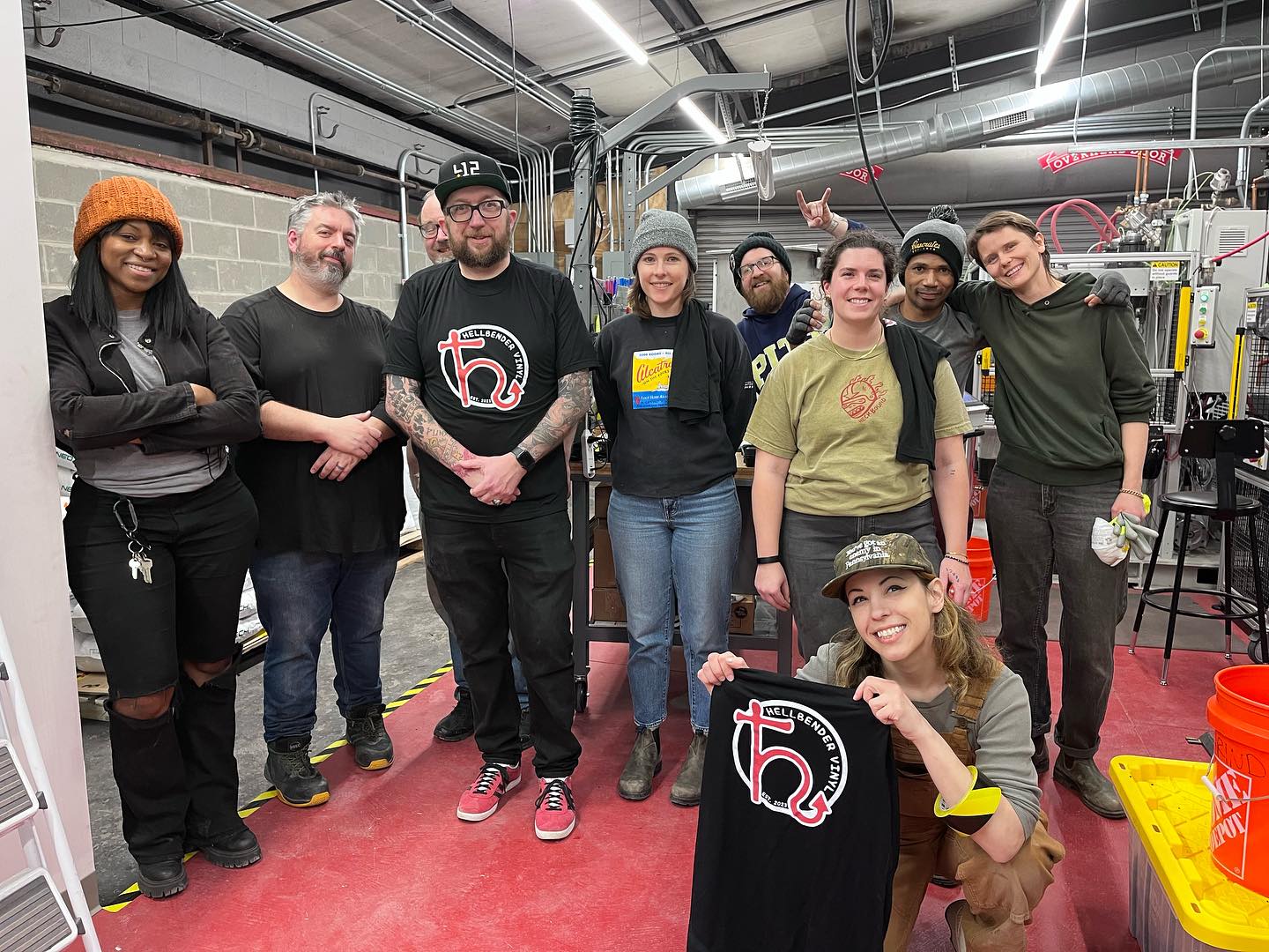 Hellbender Vinyl team members and volunteers showing off their work in their Pittsburgh-based record pressing factory.