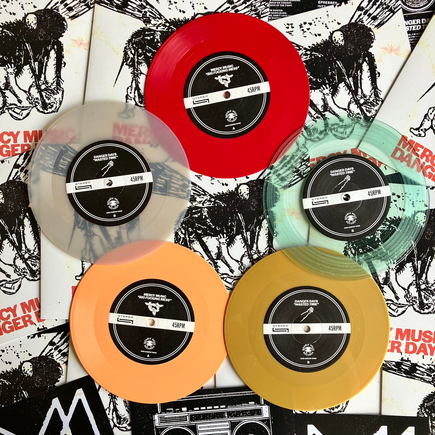 Five colored vinyl records on a graphic background