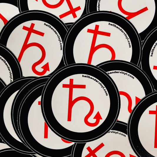 Stack of circular stickers with a red symbol and website text on a white background