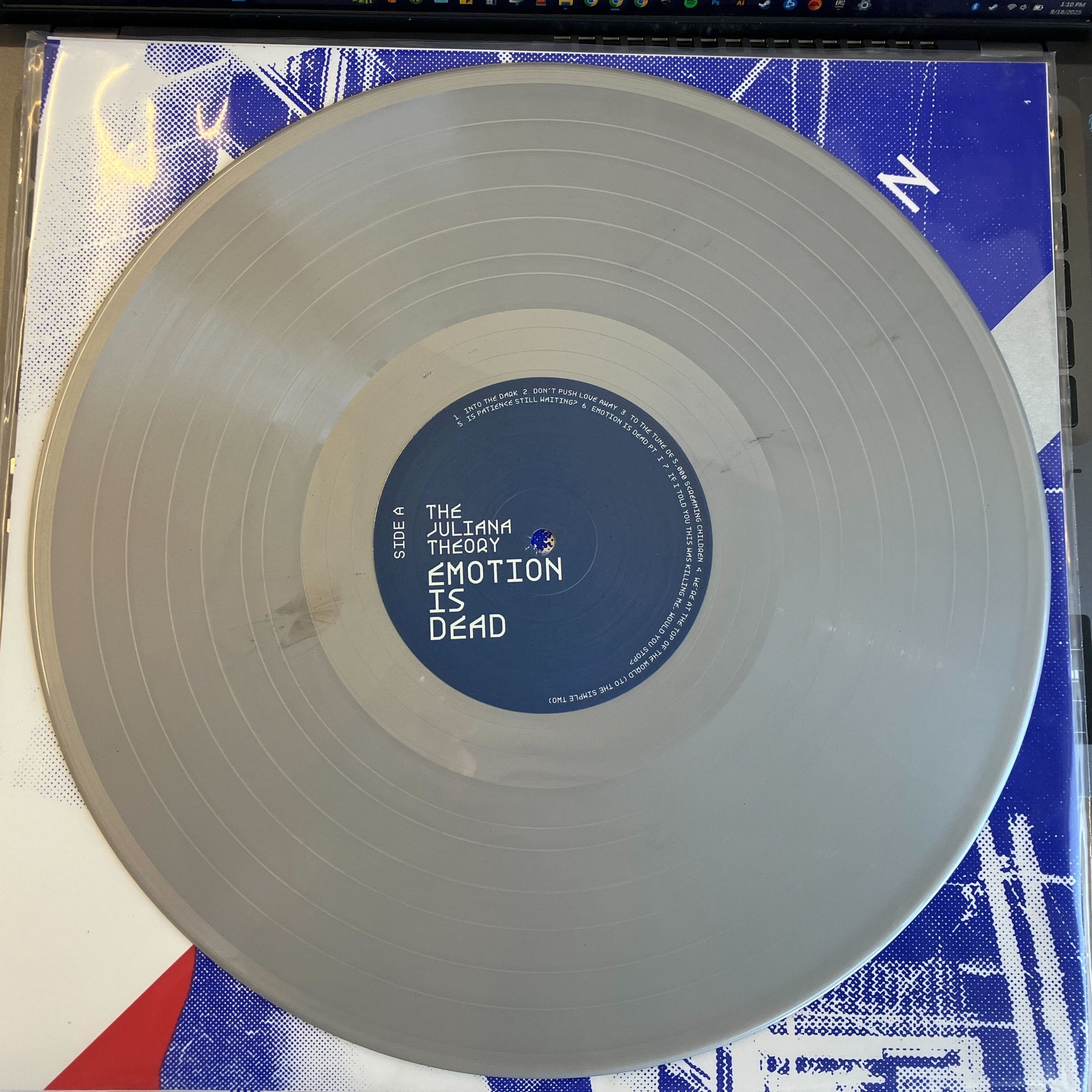 Vinyl record with a blue label on a white surface