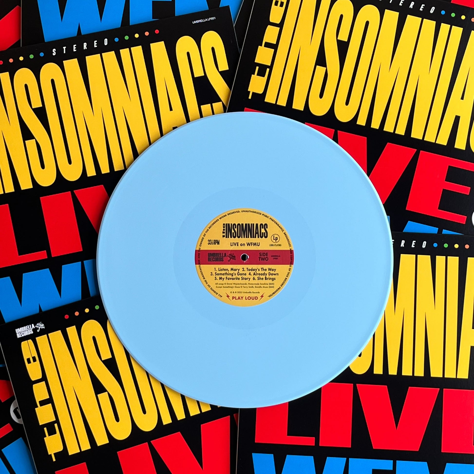 Sky blue vinyl record with a yellow label on a colorful 'The Insomnias' background