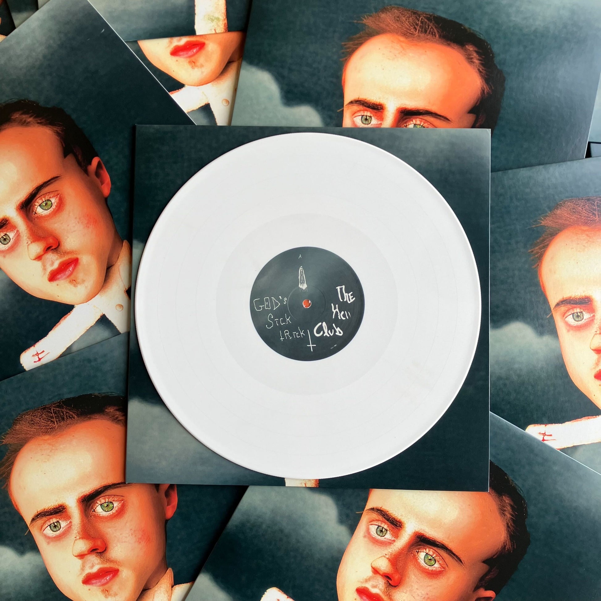 Vinyl record with a face on the cover surrounded by images of a person's face.
